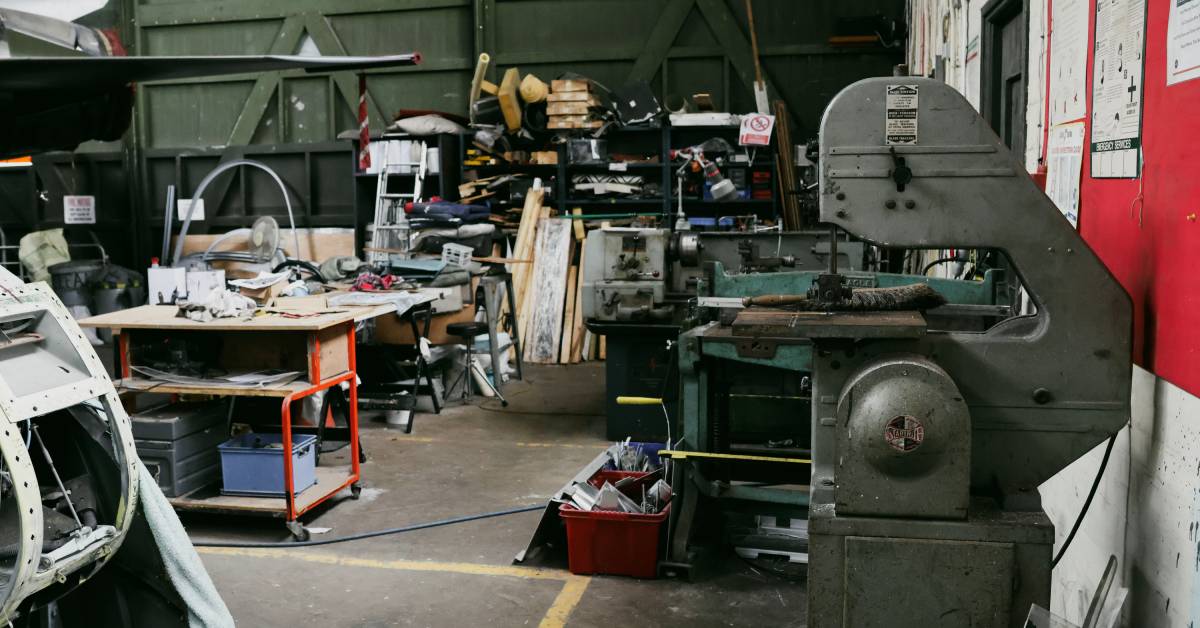 A spacious industrial workstation featuring machines, tables, and various tools arranged in various ways